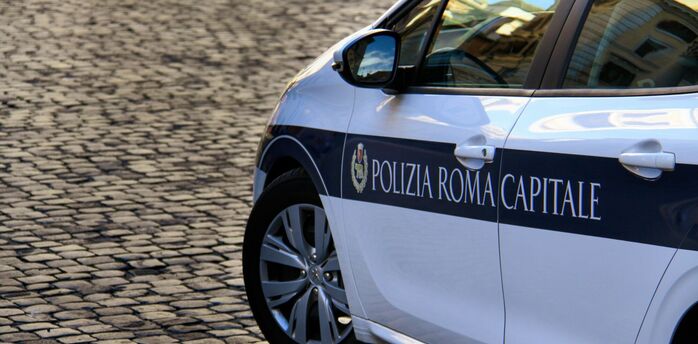 Rome traffic police car on cobblestone street