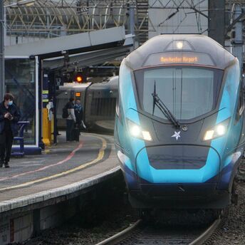 A TransPennine Express train at a station platform