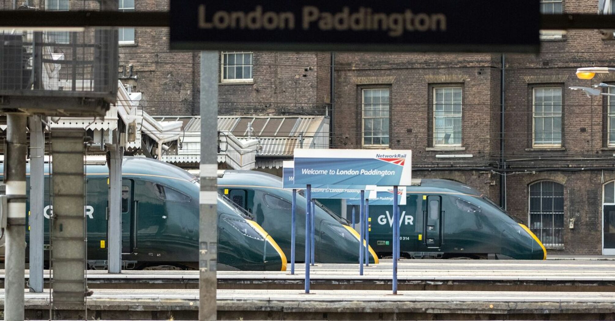 Empty platform at London Paddington station with GWR trains in the background