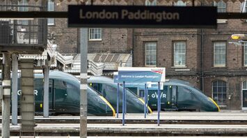 Empty platform at London Paddington station with GWR trains in the background