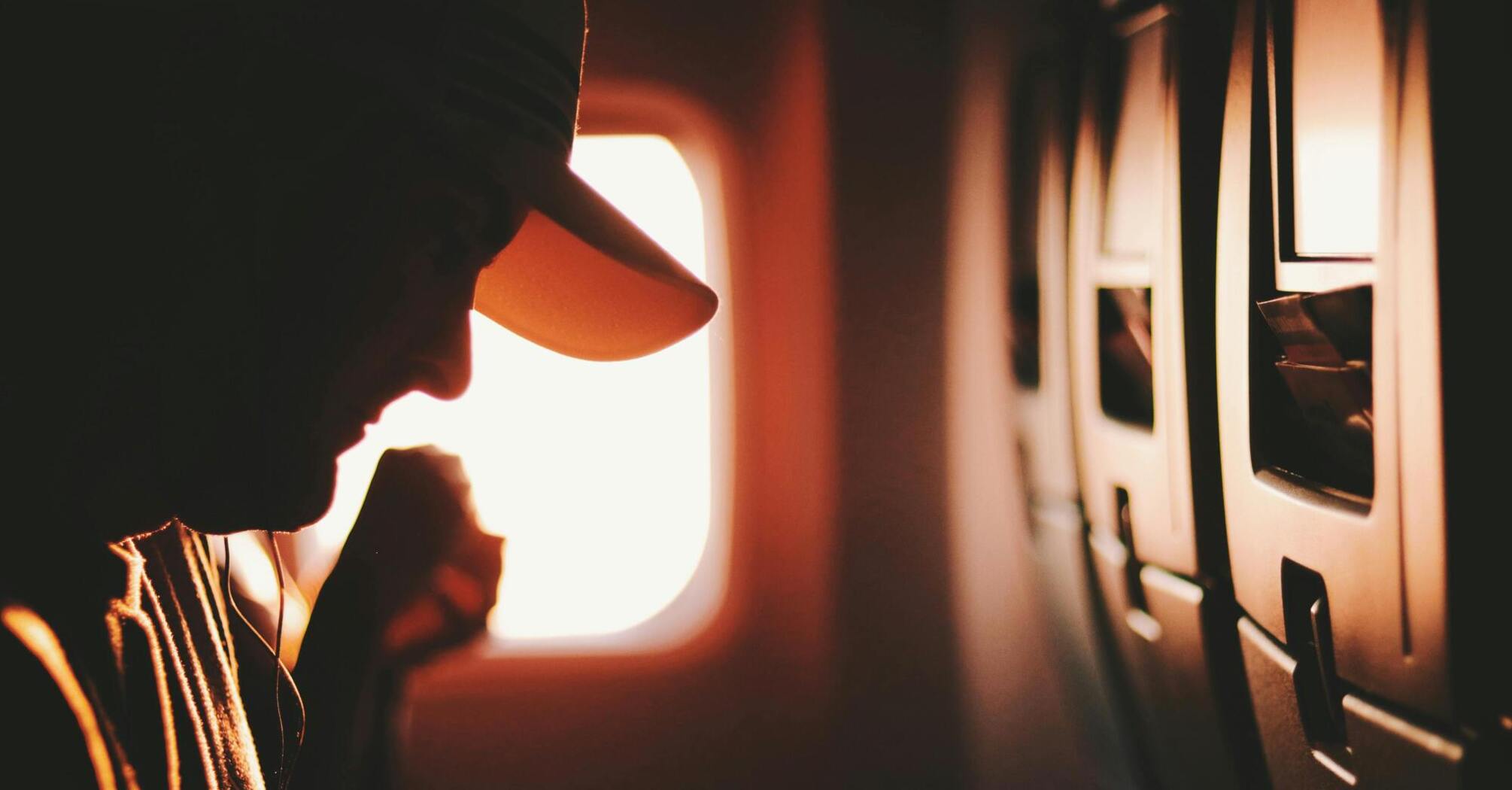 Close-up view of a passenger beside an airplane window