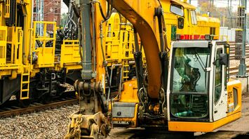 Construction equipment on railway tracks, preparing for track upgrades