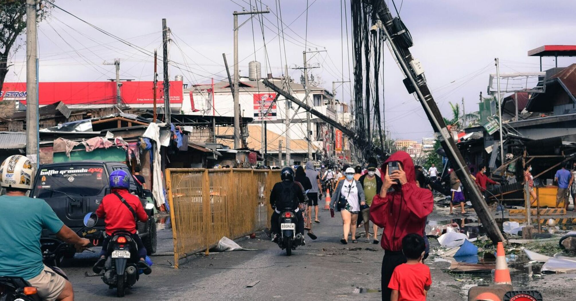 Damaged power lines and utility poles in a street affected by typhoon