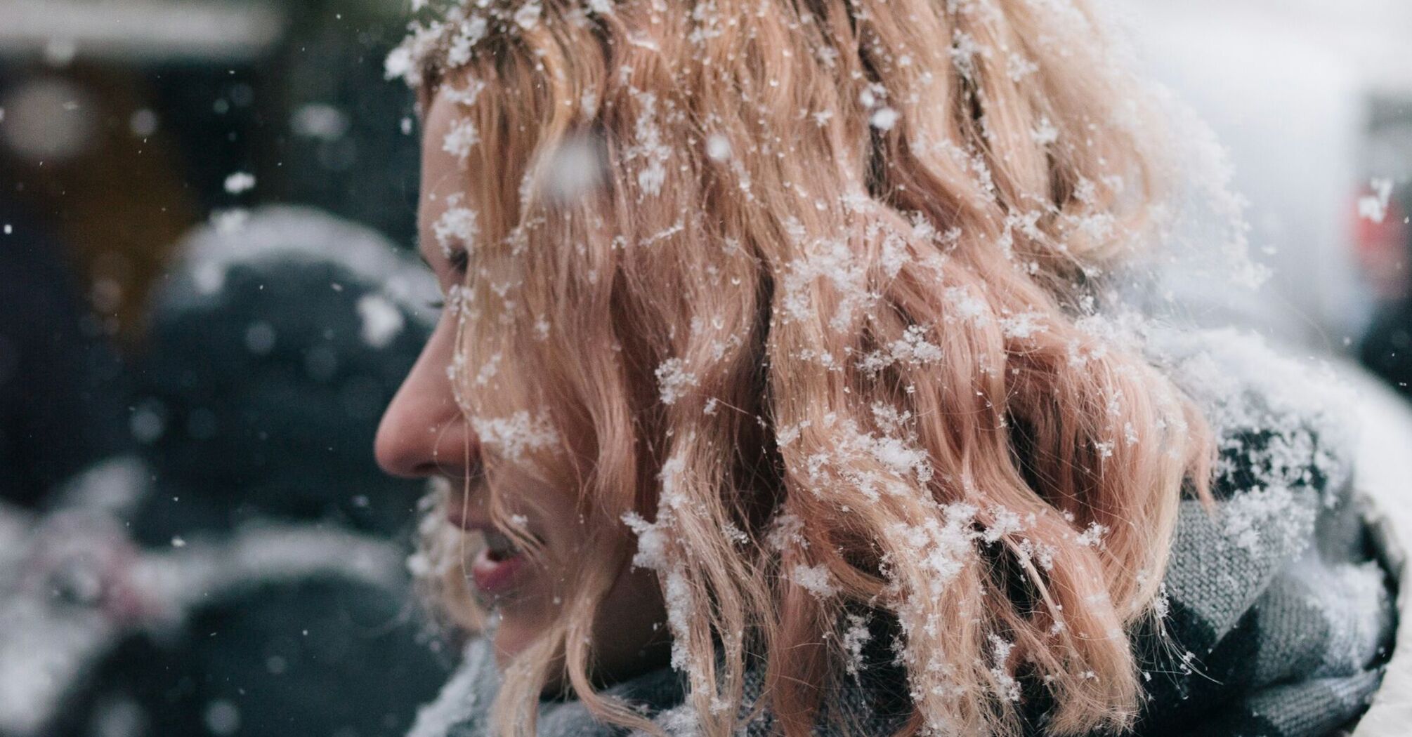 A woman with snow-covered hair in winter weather