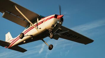 Small aircraft in flight with clear skies