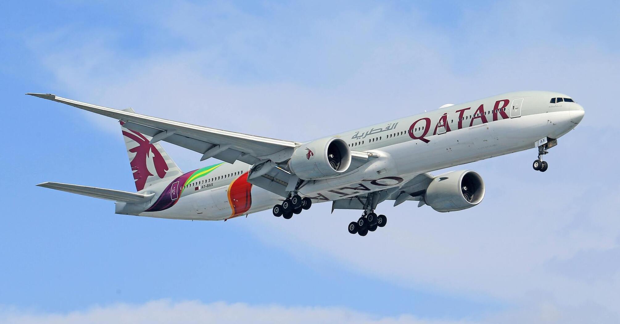 Qatar Airways airplane in flight with visible branding