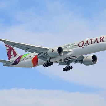 Qatar Airways airplane in flight with visible branding