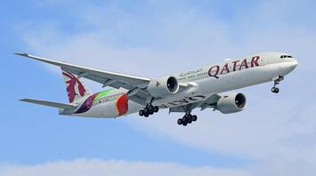 Qatar Airways airplane in flight with visible branding