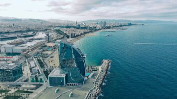 Aerial view of Barcelona's coastline with the prominent W Hotel near the beach, overlooking the Mediterranean Sea
