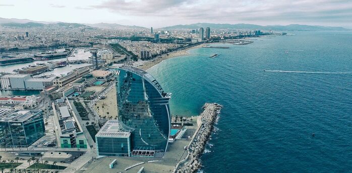 Aerial view of Barcelona's coastline with the prominent W Hotel near the beach, overlooking the Mediterranean Sea