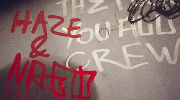 Graffiti with red and white writing on a gray wall