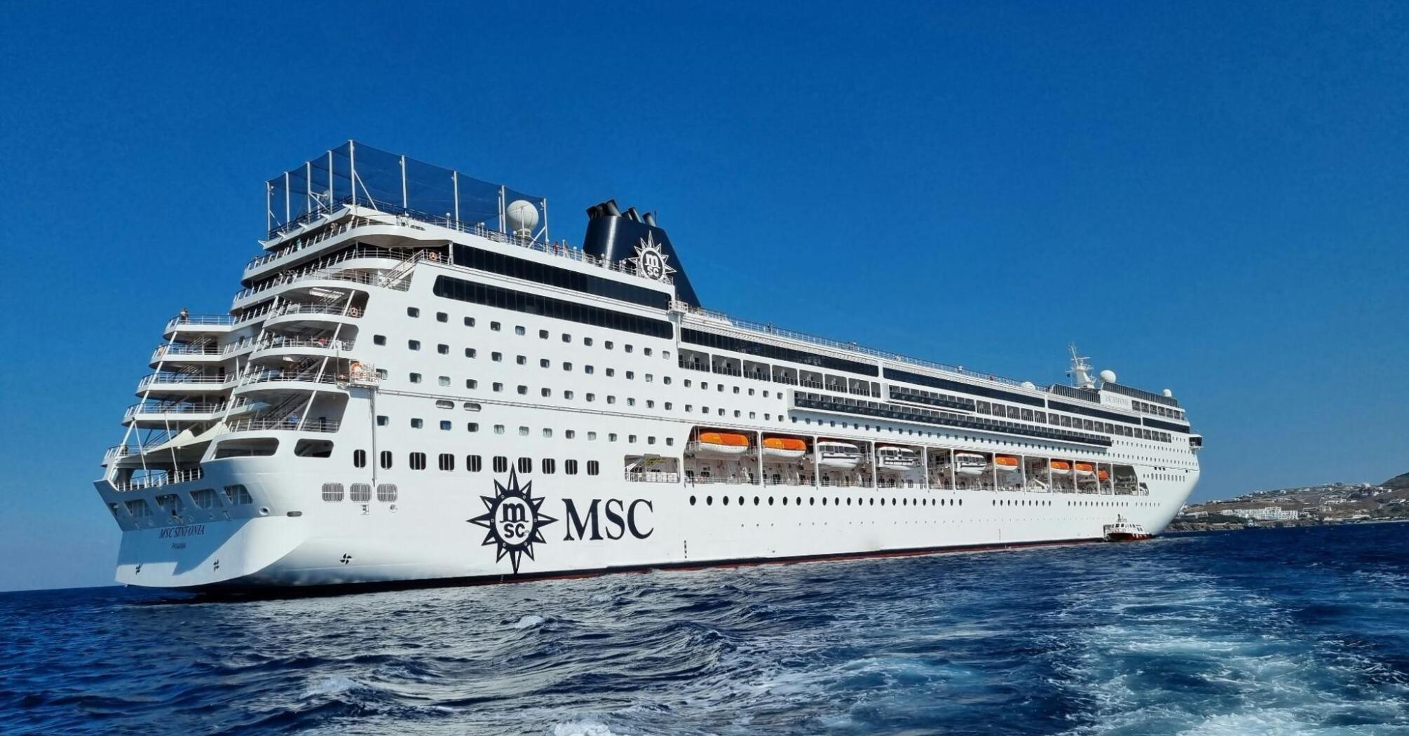 MSC cruise ship sailing in open water under a clear blue sky