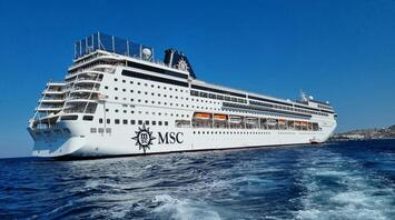 MSC cruise ship sailing in open water under a clear blue sky
