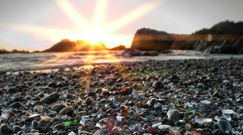 Colorful sea glass on the beach at sunset