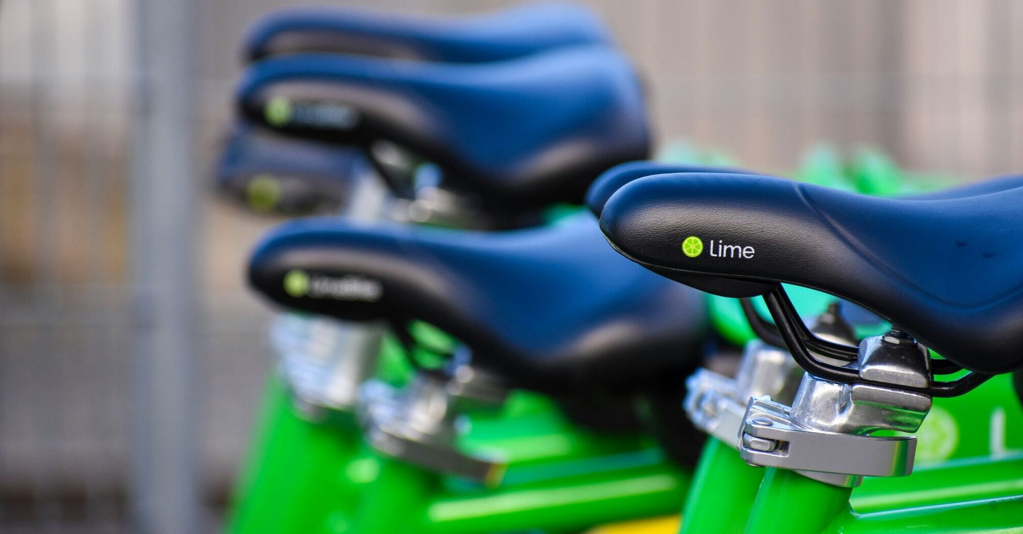 Close-up of Lime bike seats lined up