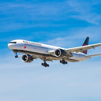 Air Canada aircraft in flight against a blue sky