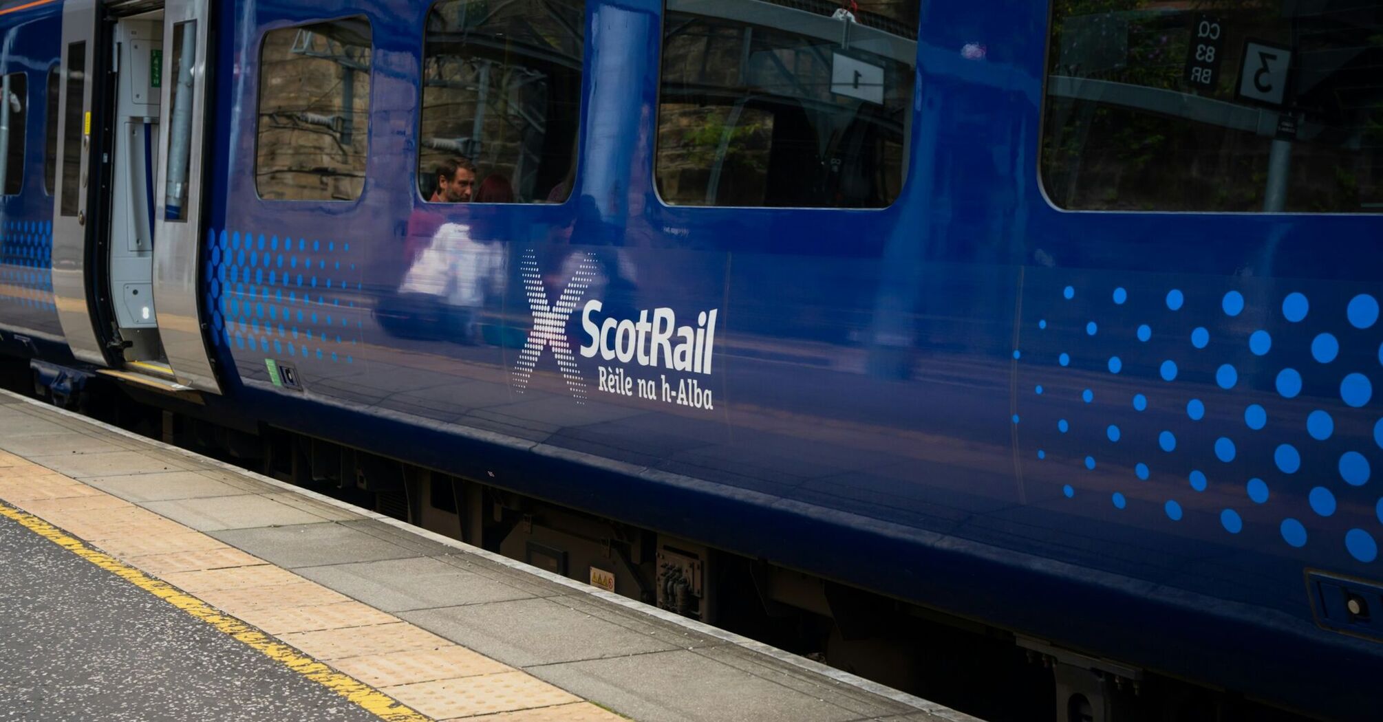 ScotRail train at a station platform in Scotland