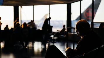 Passengers waiting at an airport gate