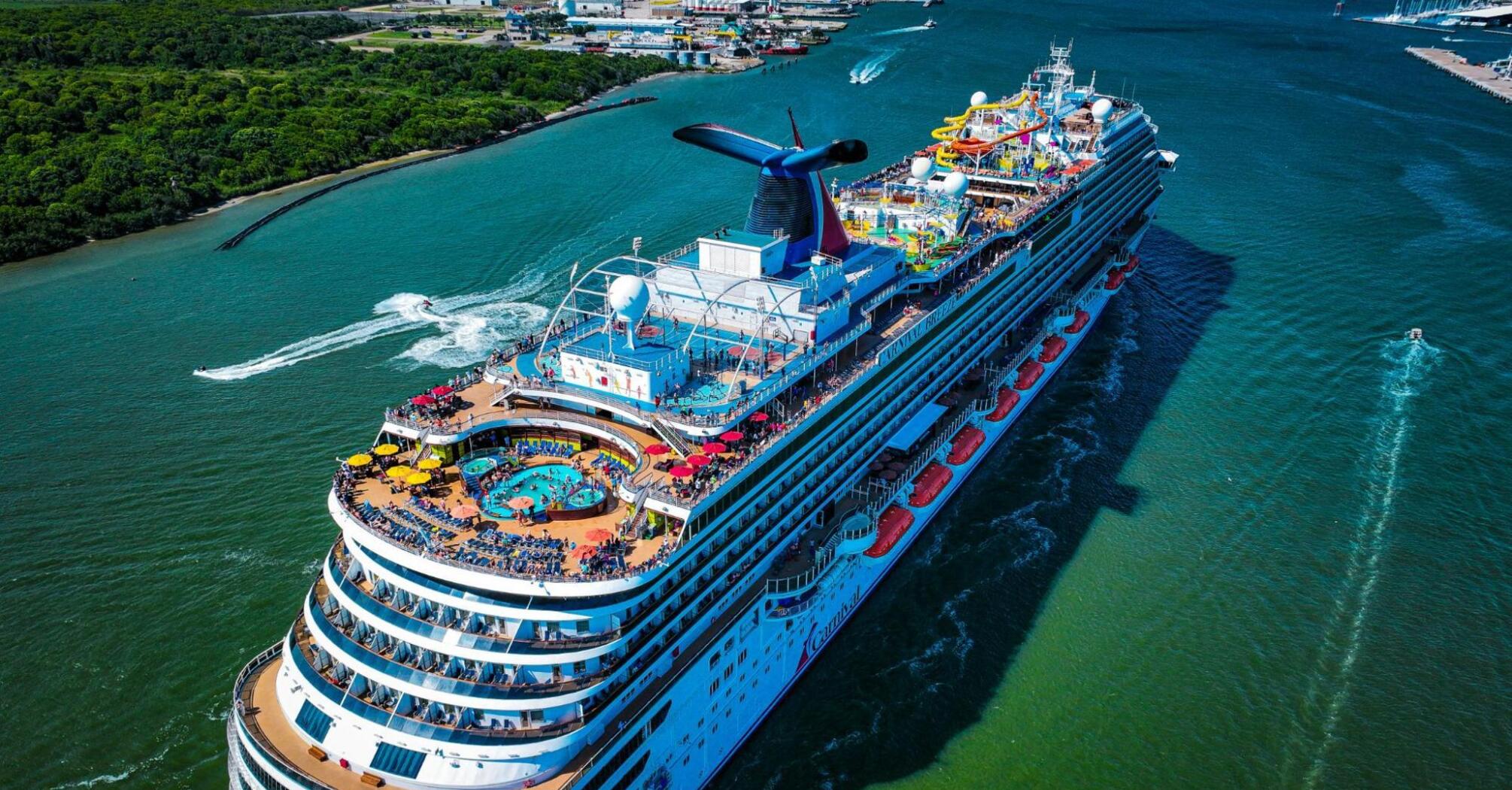 A Carnival Cruise Line ship sailing through a scenic waterway, showcasing onboard activities and amenities