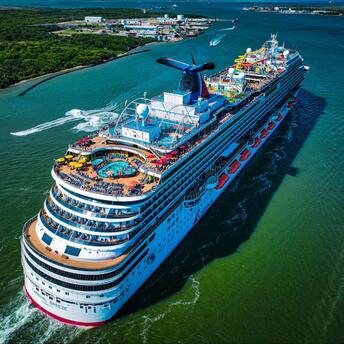 A Carnival Cruise Line ship sailing through a scenic waterway, showcasing onboard activities and amenities