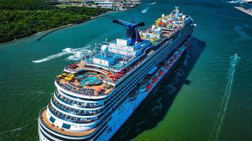 A Carnival Cruise Line ship sailing through a scenic waterway, showcasing onboard activities and amenities