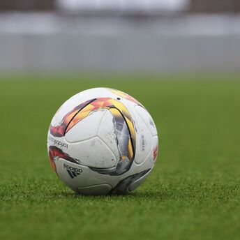 A soccer ball resting on a grassy field