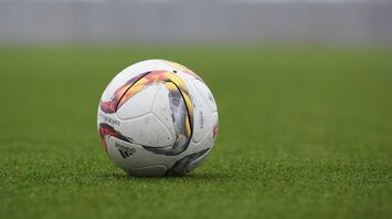 A soccer ball resting on a grassy field