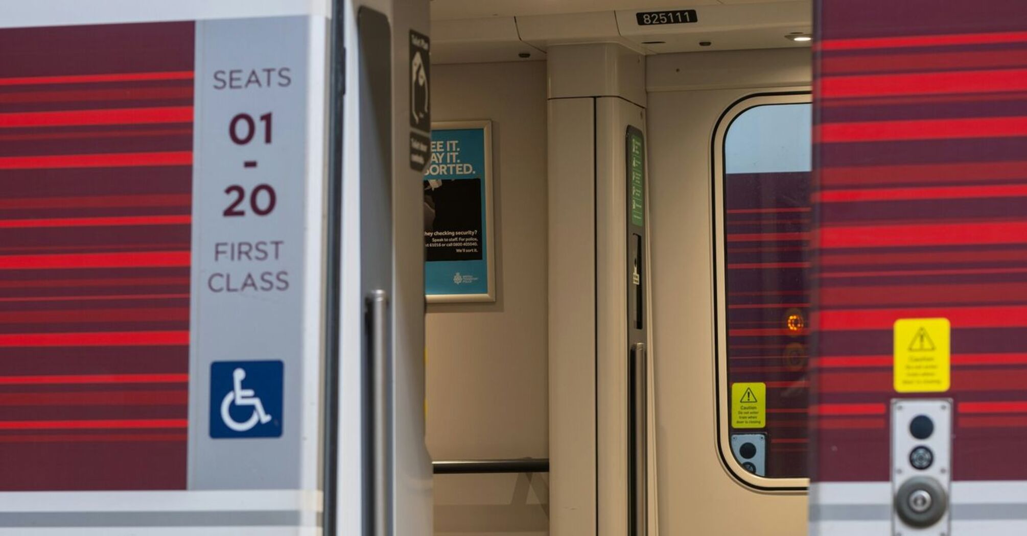 Open first-class train door showing accessible entrance