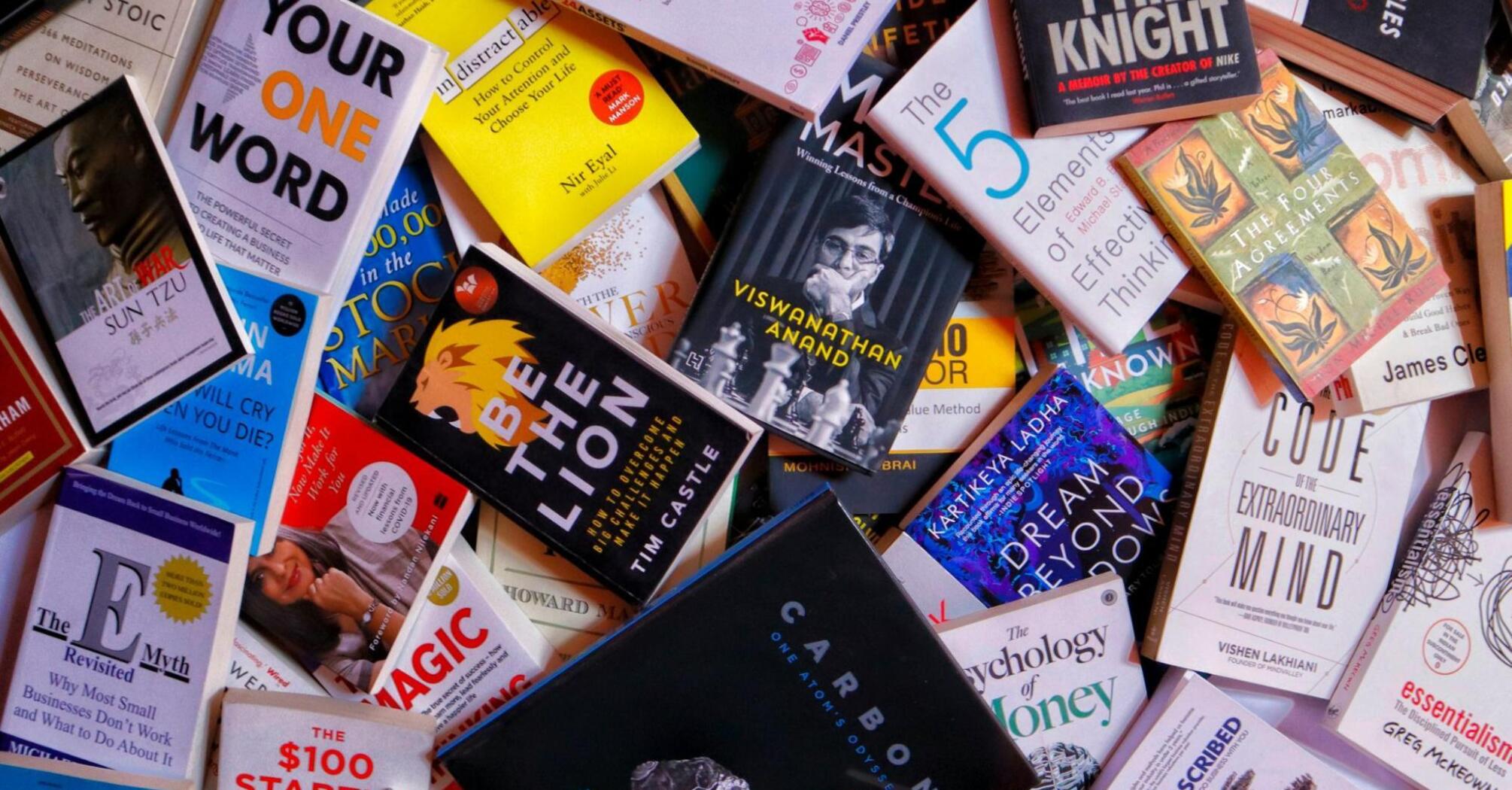 A colorful assortment of books spread out, featuring various titles on self-improvement, business, and creativity