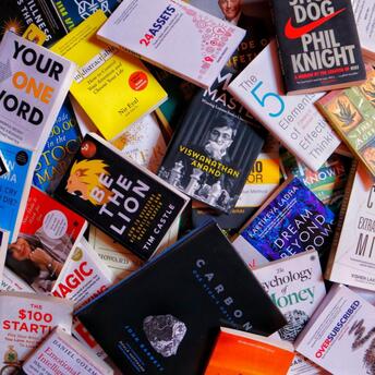 A colorful assortment of books spread out, featuring various titles on self-improvement, business, and creativity