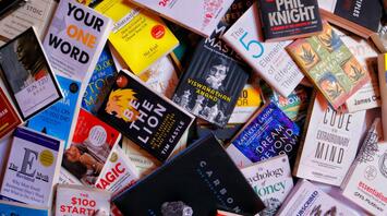 A colorful assortment of books spread out, featuring various titles on self-improvement, business, and creativity