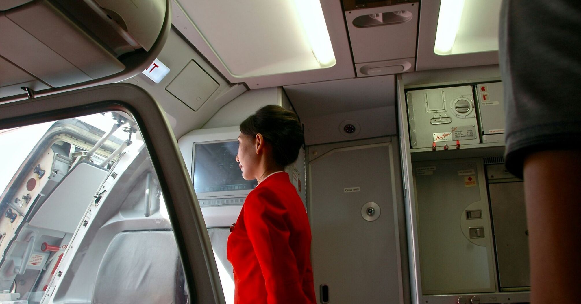 woman standing near airplane cockpit door