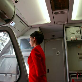 woman standing near airplane cockpit door