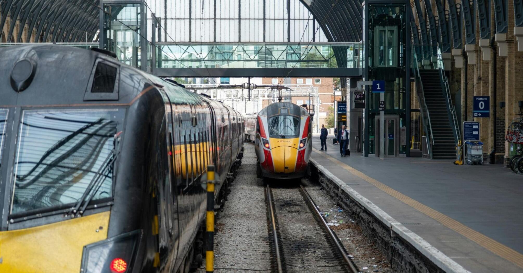 Modern trains at a European railway station under a large glass canopy