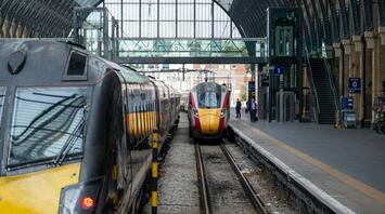 Modern trains at a European railway station under a large glass canopy