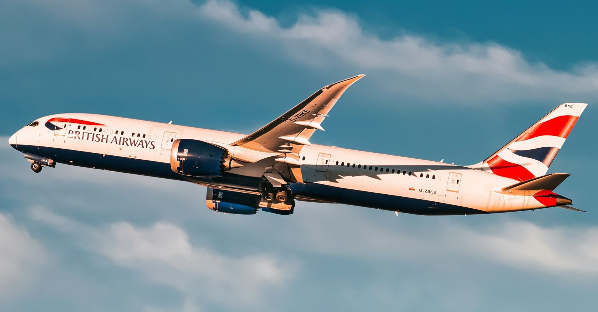 A British Airways aircraft taking off against a blue sky