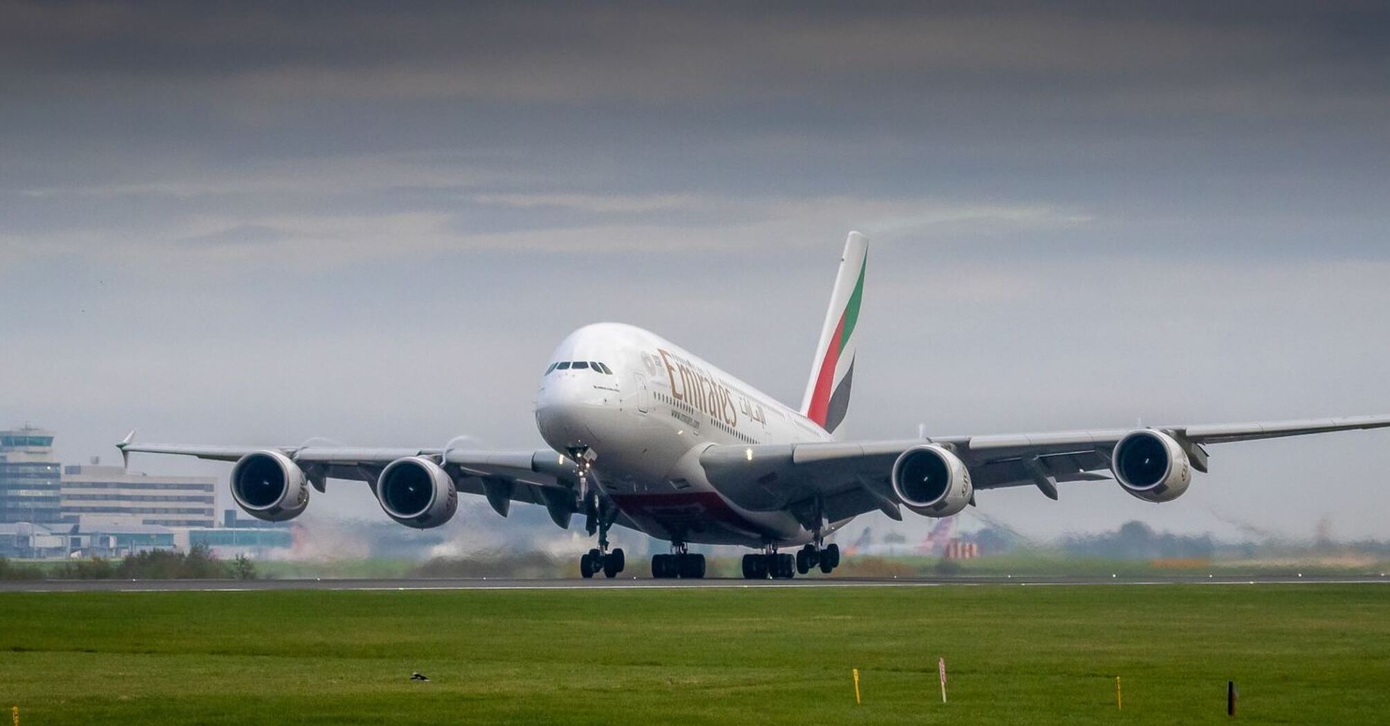 Emirates aircraft preparing for takeoff at an international airport