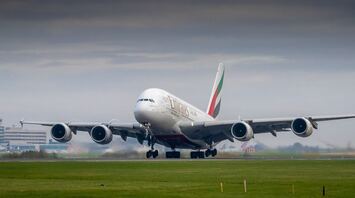 Emirates aircraft preparing for takeoff at an international airport
