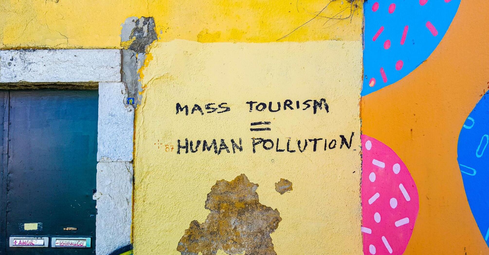 Graffiti criticizing the environmental and social impact of mass tourism