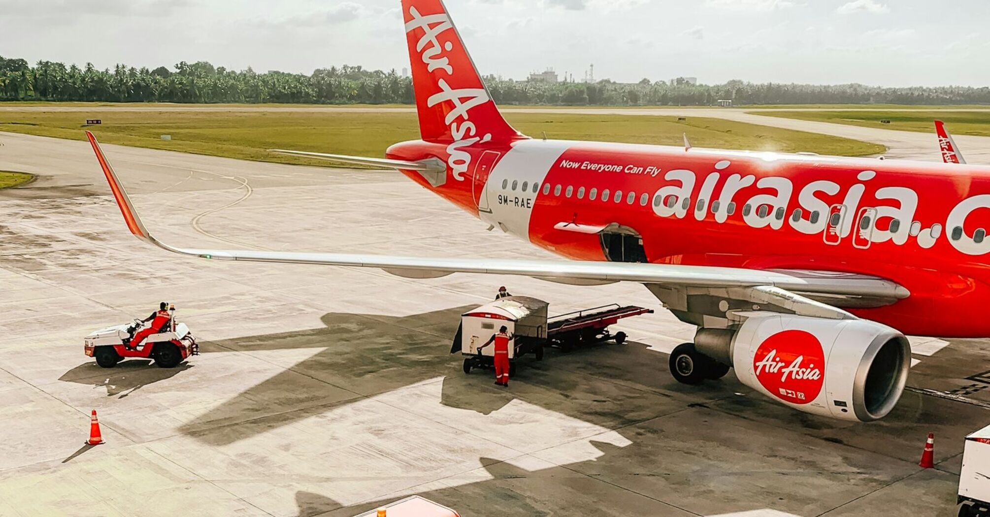 AirAsia X airplane on the tarmac with ground support vehicles