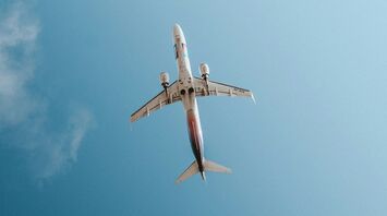 Air Montenegro airplane flying against a clear blue sky