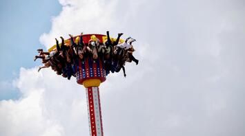 People enjoying a thrilling drop tower ride at an amusement park
