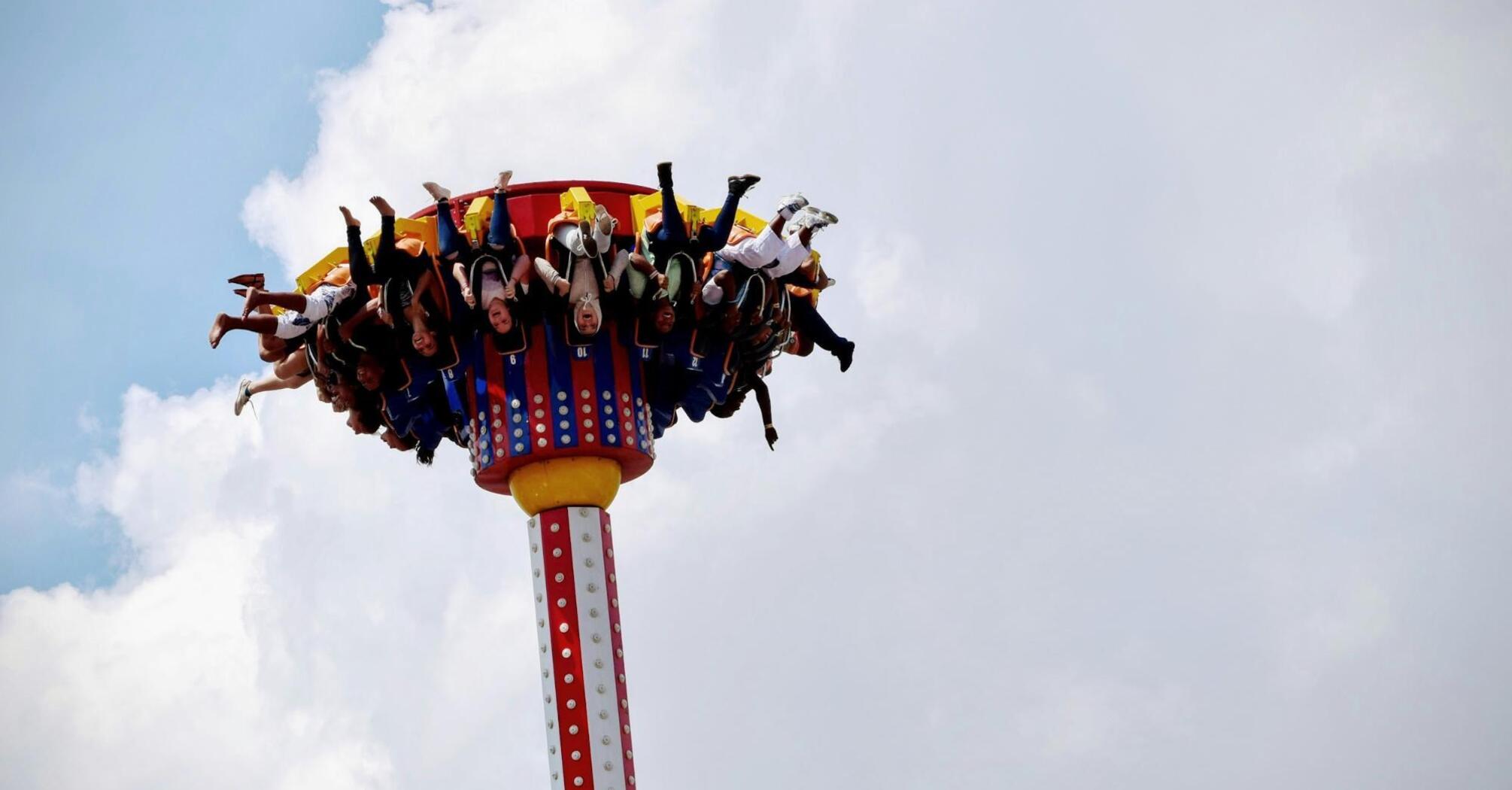 People enjoying a thrilling drop tower ride at an amusement park