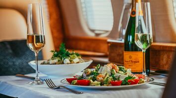 Gourmet meal with champagne served in a luxury airplane cabin