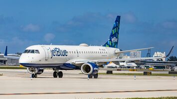 JetBlue Embraer aircraft on runway at an airport