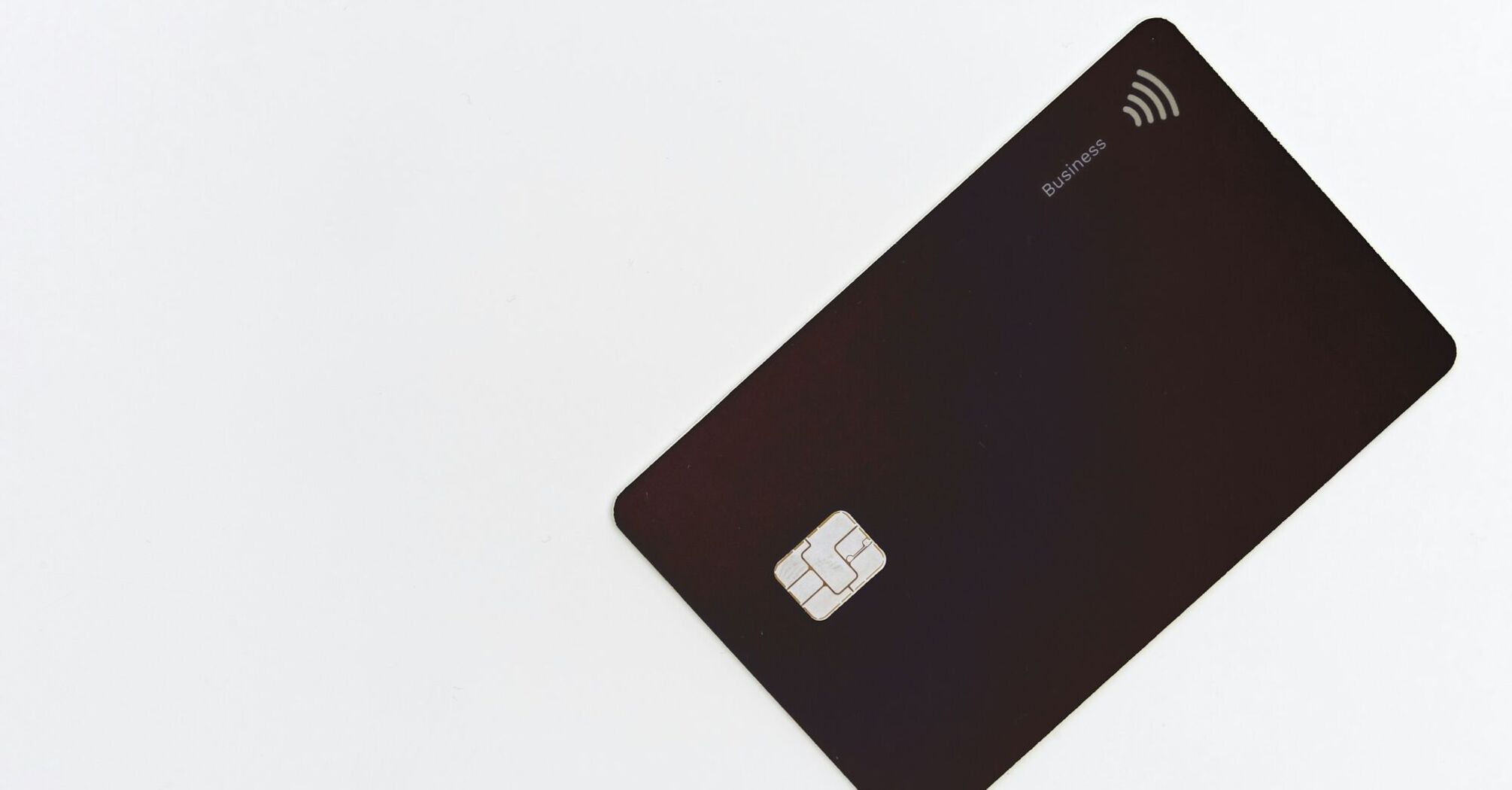 Black credit card with contactless symbol on white background