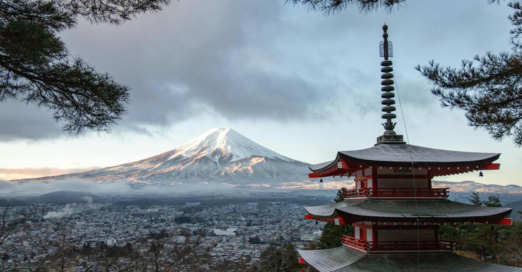 Snowcapped Mount Fuji with a traditional pagoda in foreground