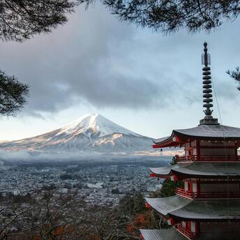 Snowcapped Mount Fuji with a traditional pagoda in foreground