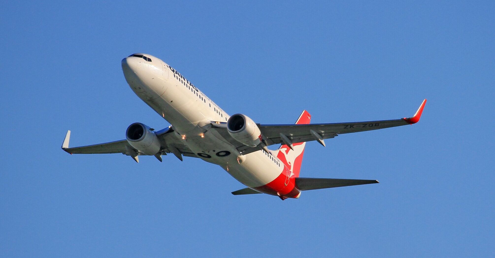 Qantas plane in flight against blue sky