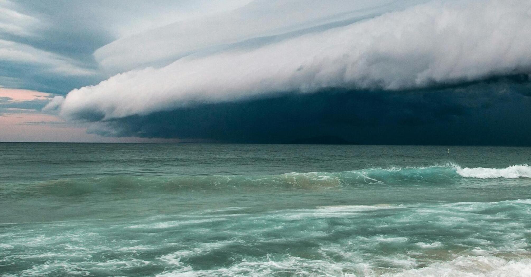 Stormy clouds approaching over the ocean waves